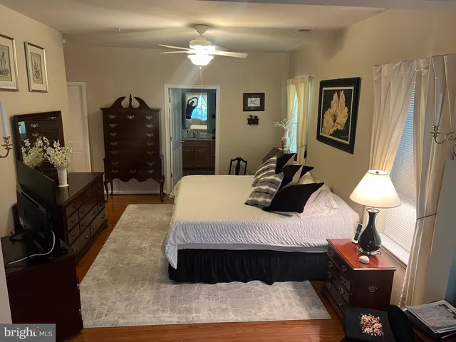 a bedroom with a bed lamps and a dresser
