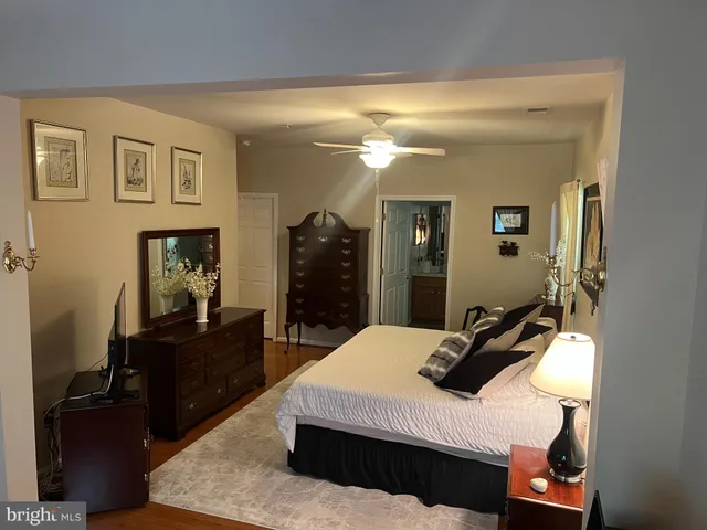 a bedroom with a bed and a mirror