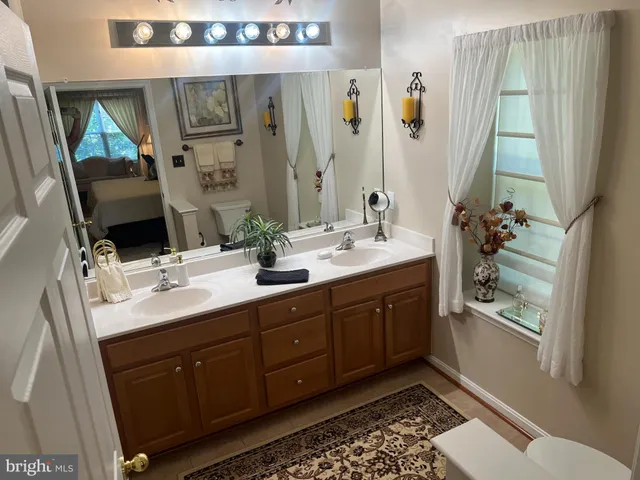 a bathroom with a double vanity sink mirror and double