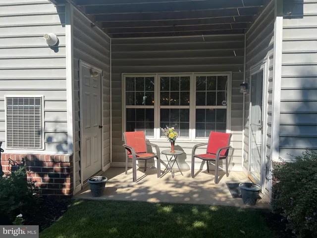 a couple of chairs sitting in front of house