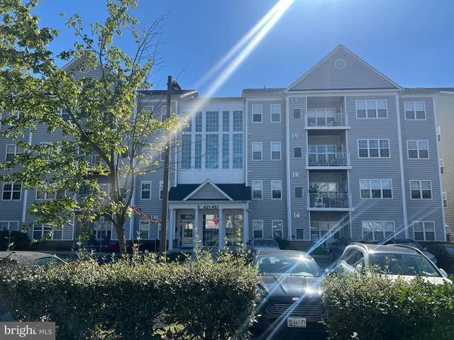 a front view of a residential apartment building with a yard