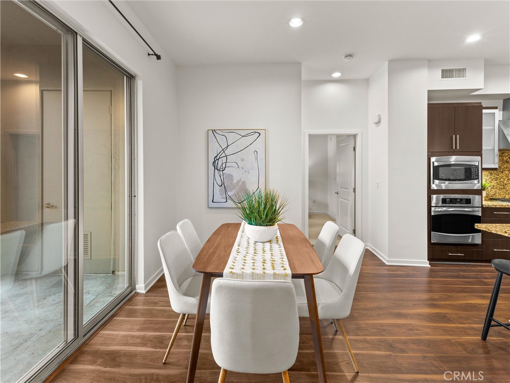 21 Gramercy, Unit 208 Irvine, CA 92612 - Photo 12 of 31 a view of a dining room with furniture and wooden floor
