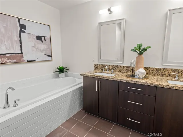 a bathroom with a tub sink and mirror