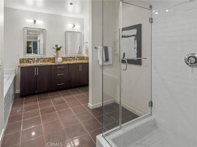 a bathroom with a shower a mirror and a sink
