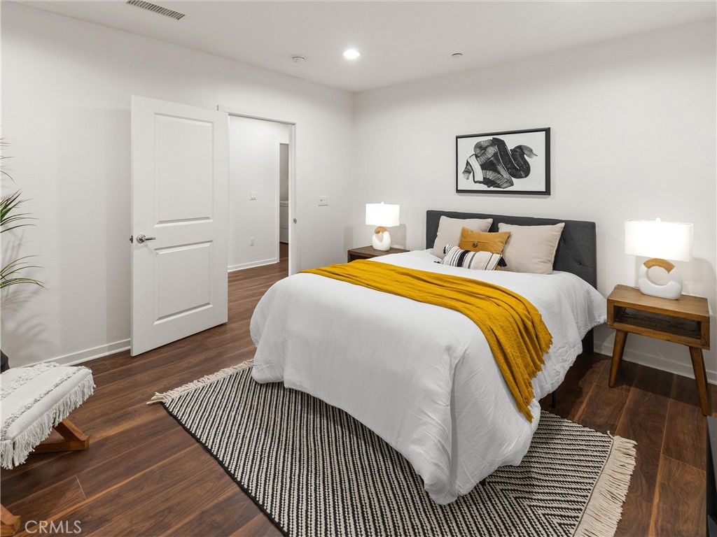 21 Gramercy, Unit 208 Irvine, CA 92612 - Photo 8 of 31 a bedroom with bed and a night stand