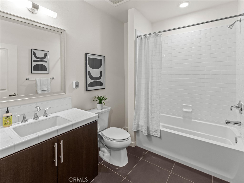 21 Gramercy, Unit 208 Irvine, CA 92612 - Photo 9 of 31 a bathroom with a sink a toilet and shower