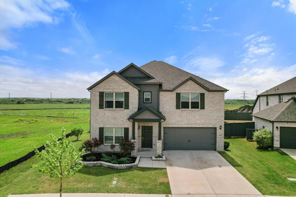 6910 Prairieside Trail Venus, TX 76084 - Photo 1 of 40 This property features a two-story brick & stone exterior with a gray roof and dark gray trim.