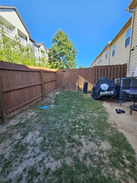 5747 Radford Loop Fairburn, GA 30213 - Photo 30 of 36 a view of a house with a yard and wooden fence