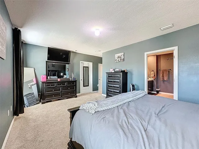 a view of a hallway with workspace and a couch