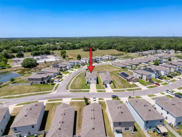a view of a house with a swimming pool and a yard