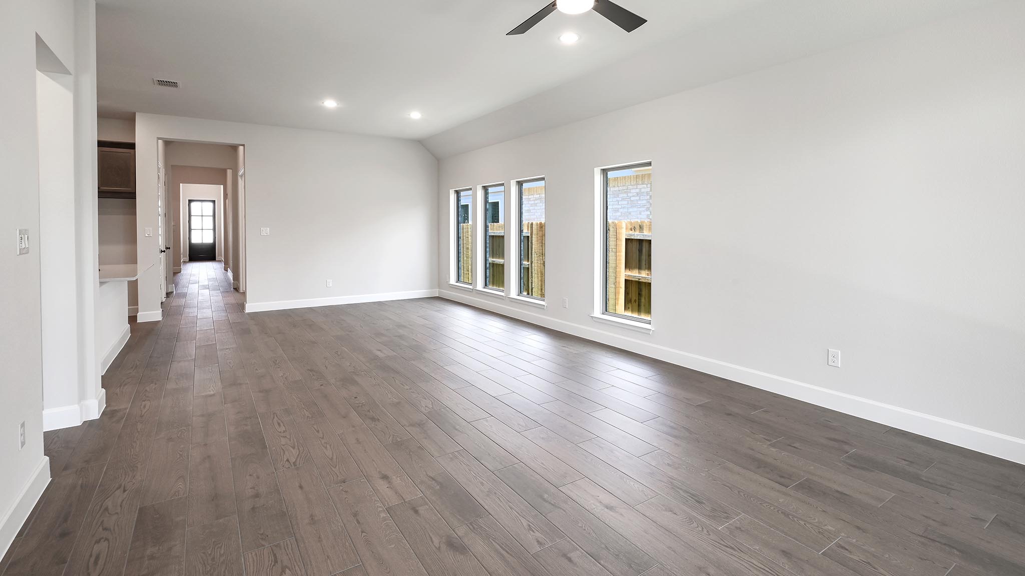 126 Basket Flower Loop Kyle, TX 78640 - Photo 9 of 29 wooden floor in an empty room with a window