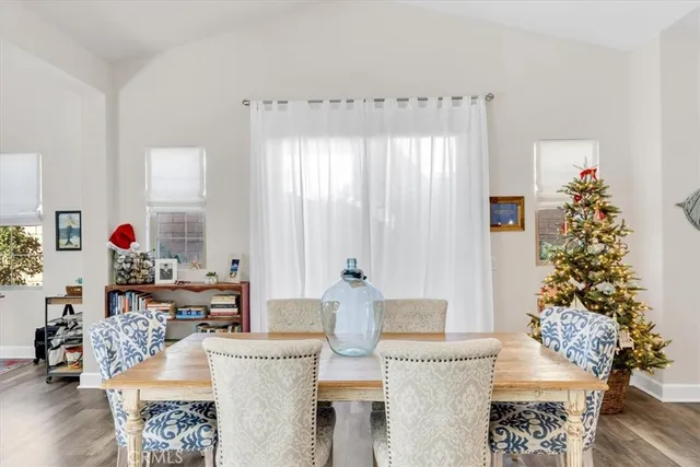 a living room with furniture a flat screen tv and a large window