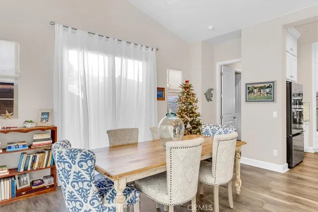 a spacious bedroom with a bed a couch and a chandelier