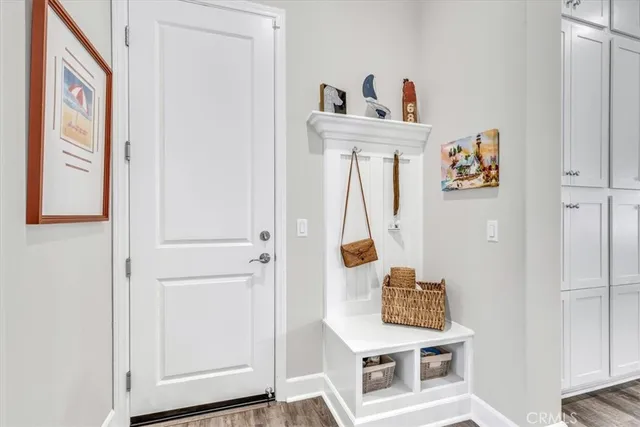 a kitchen with stainless steel appliances a dining table chairs refrigerator and stove