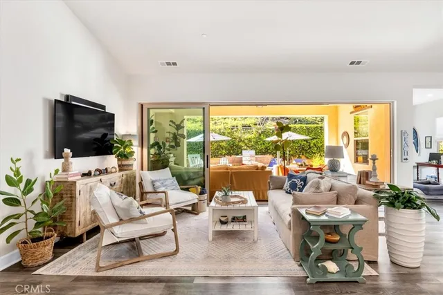 a view of a dining room with furniture large windows and wooden floor