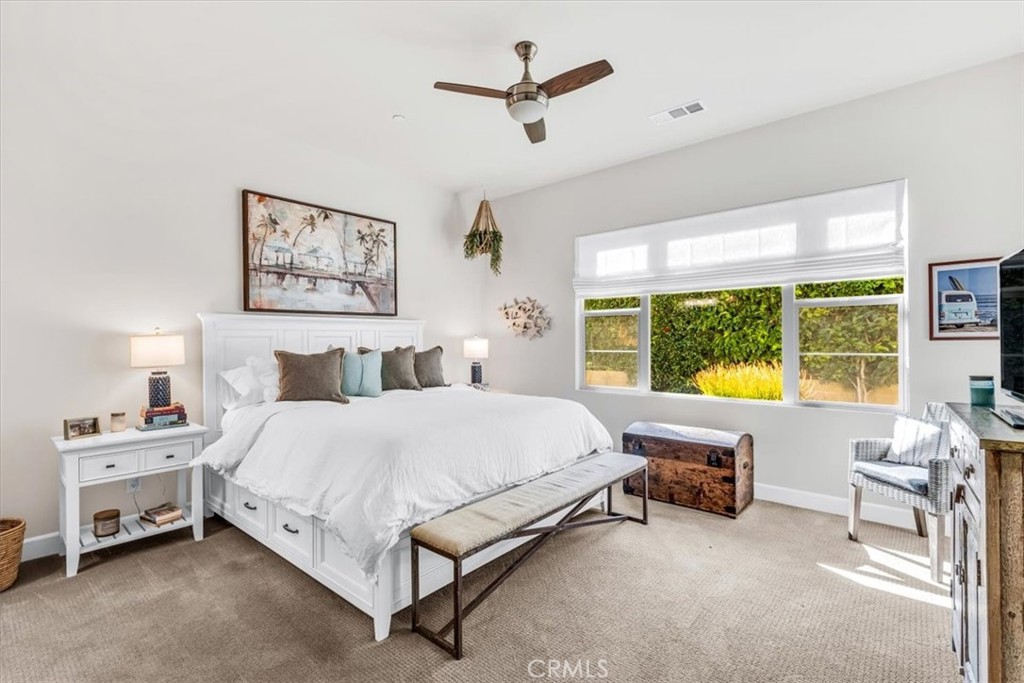17 Puesto Road Rancho Mission Viejo, CA 92694 - Photo 16 of 69 a spacious bedroom with a bed a couch and a chandelier