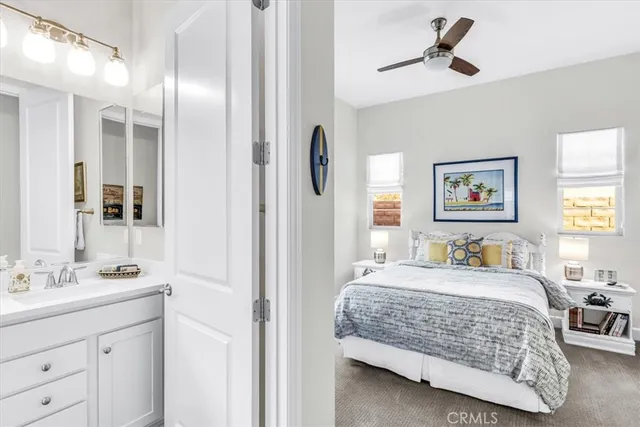 a backyard of a house with table and chairs under an umbrella