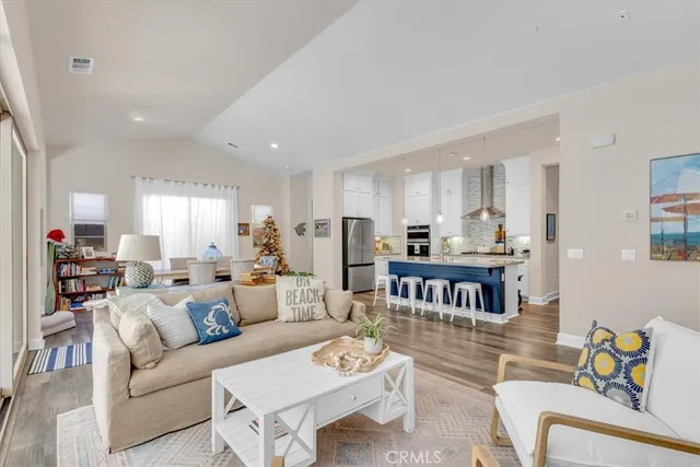 a kitchen with stainless steel appliances granite countertop a kitchen island hardwood floor and a sink