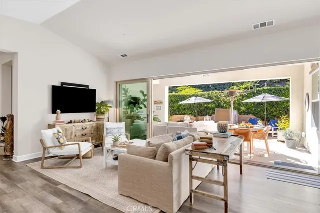 a living room with furniture wooden floor and a flat screen tv
