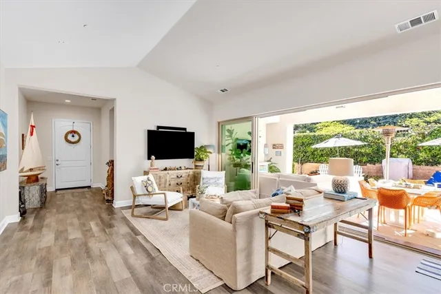 a kitchen with stainless steel appliances a dining table chairs refrigerator and stove