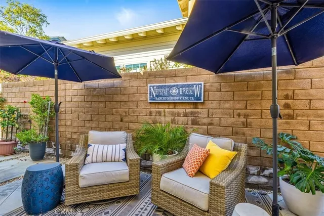 a view of a backyard with plants and a fountain