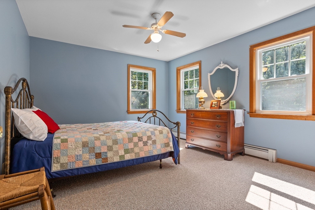 80 Ames Road Groton, MA 01450 - Photo 26 of 40 a bedroom with a bed and wooden floor