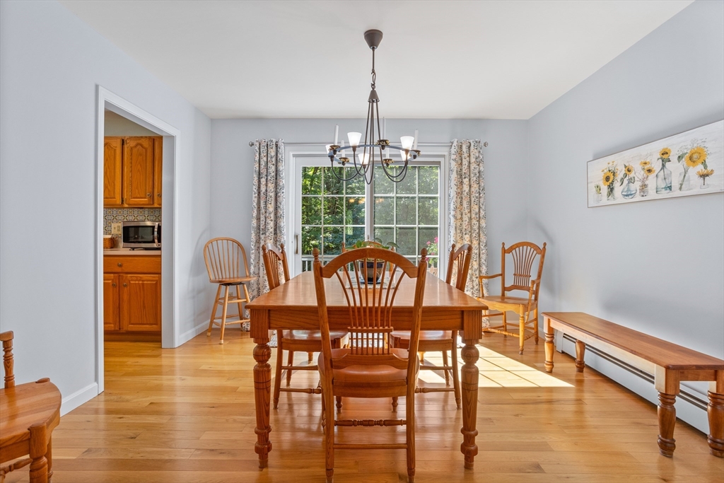 80 Ames Road Groton, MA 01450 - Photo 5 of 40 a view of a dining room with furniture window and wooden floor