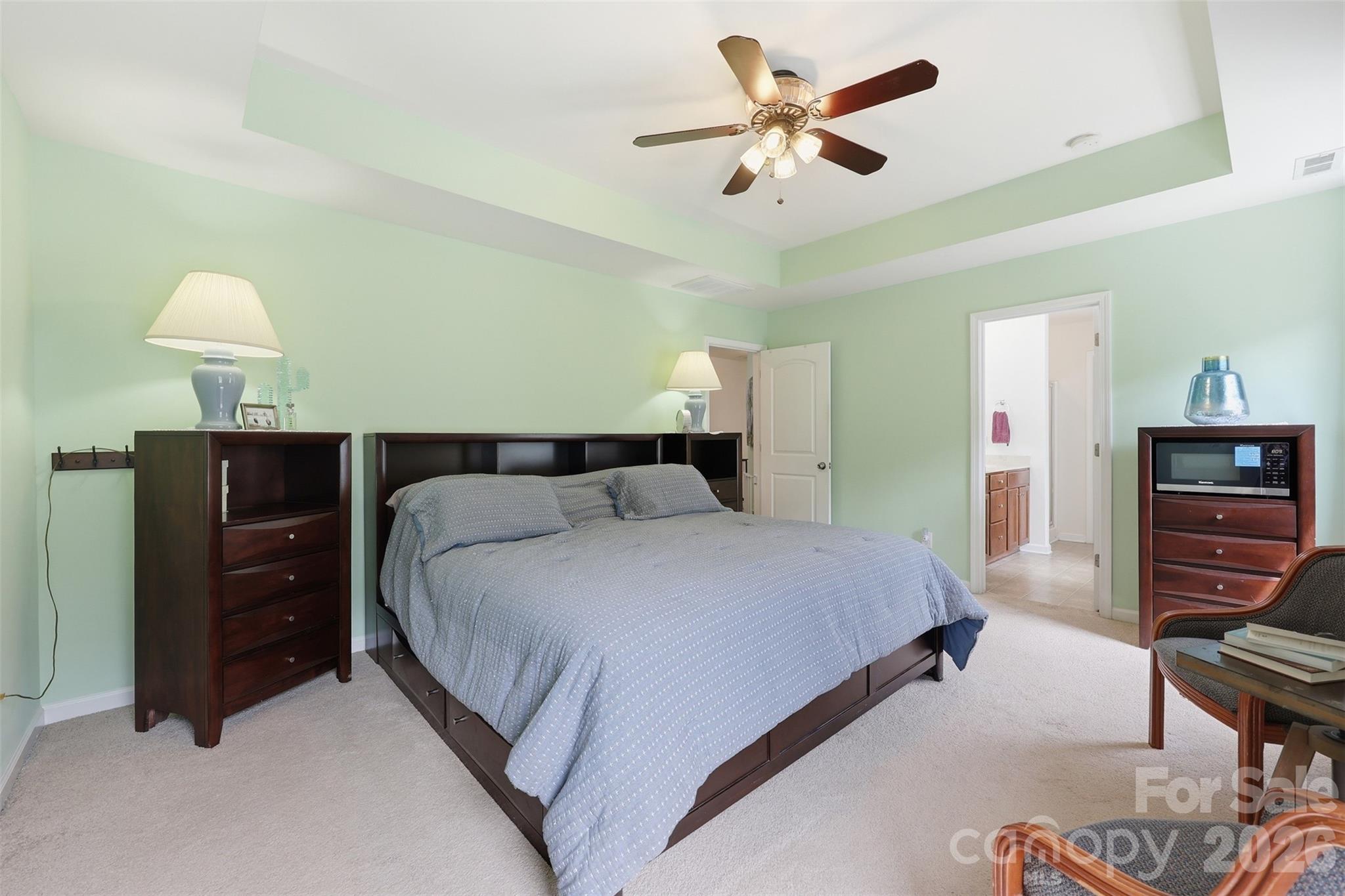 879 Ivy Trail Way Fort Mill, SC 29715 - Photo 12 of 44 a bedroom with a bed and a chandelier