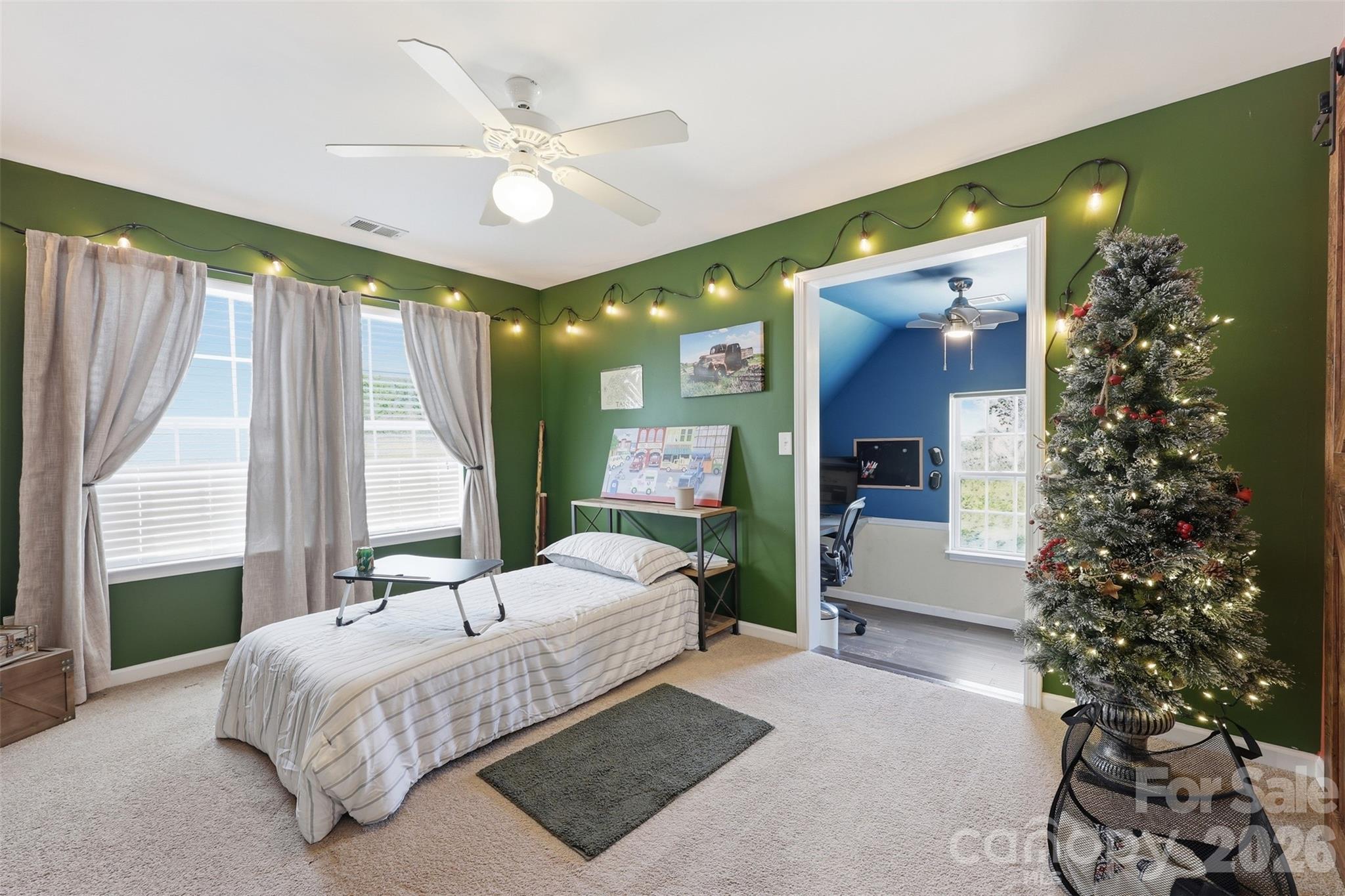 879 Ivy Trail Way Fort Mill, SC 29715 - Photo 15 of 44 a spacious bedroom with a large bed and a chandelier