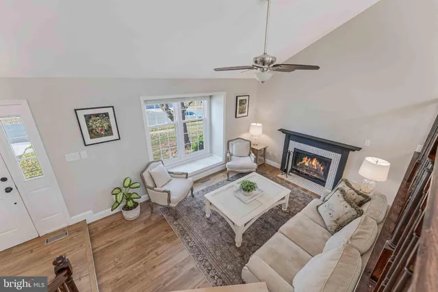 a living room with furniture a dining table and a chandelier