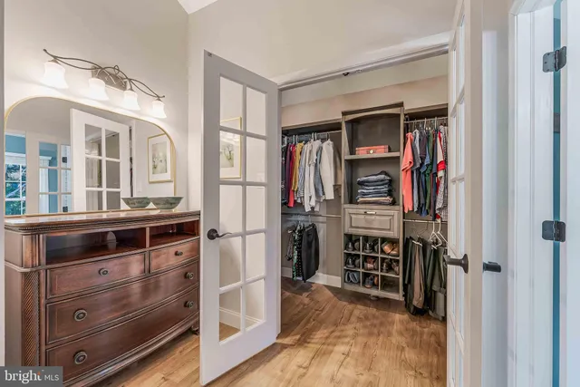 a bathroom with a granite countertop sink a toilet and window