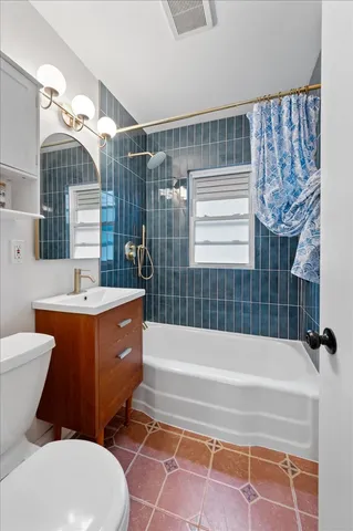 a bathroom with a sink a toilet a bathtub and shower