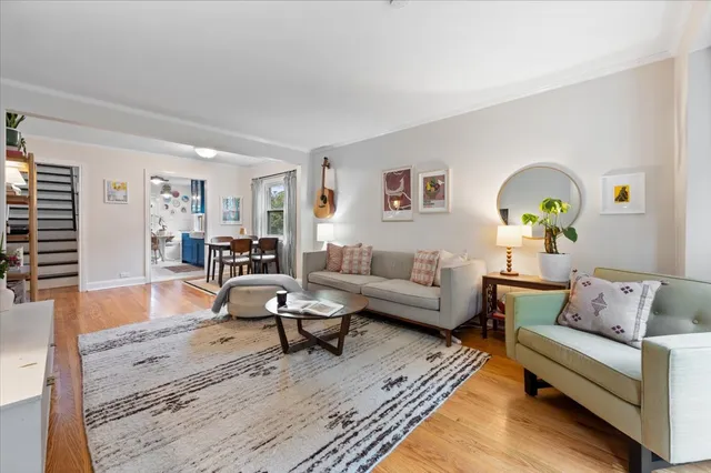 a living room with furniture and wooden floor