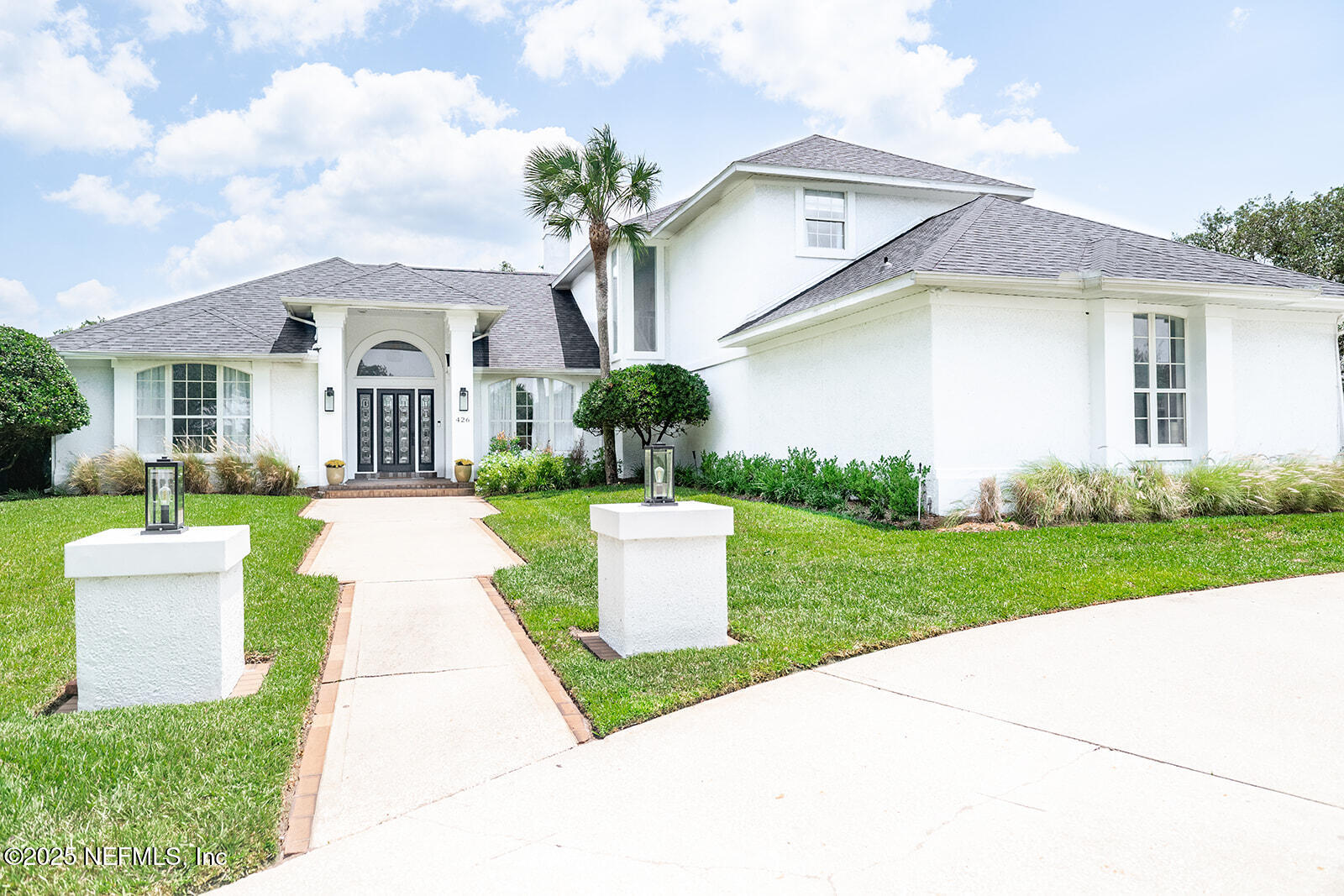 a front view of house with yard and green space