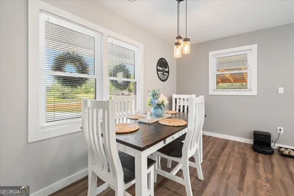 a view of a dining room with furniture large window and wooden floor