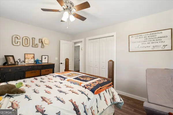 a bedroom with a bed and a dresser