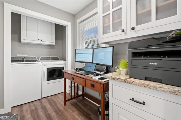 a kitchen with a stove and white cabinets