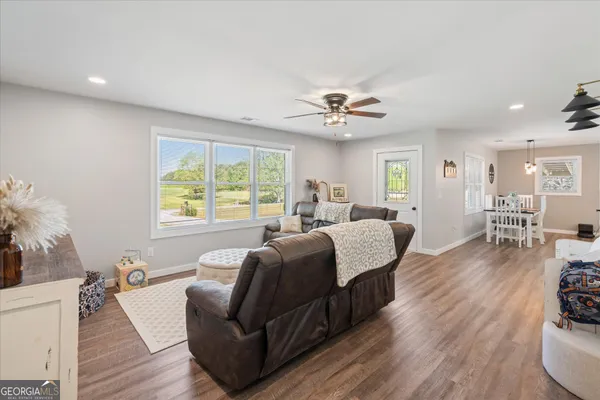 a living room with furniture and a large window