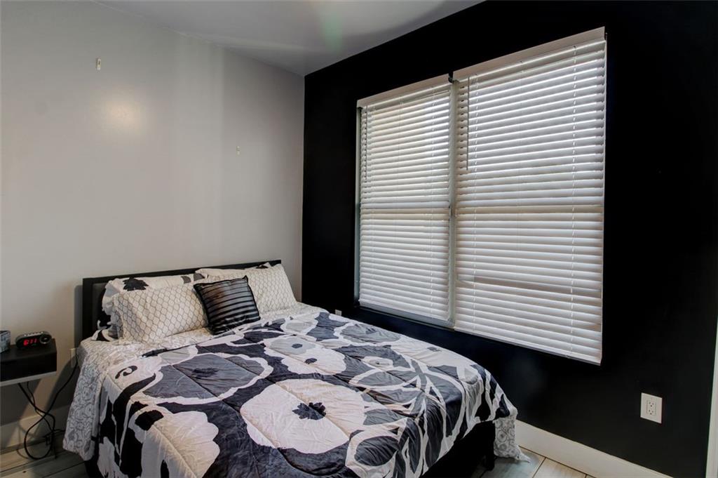 870 Mayson Turner Road Northwest, Unit 1102 Atlanta, GA 30314 - Photo 13 of 27 a bedroom with a bed and a window