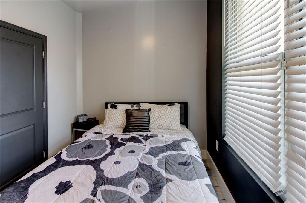 870 Mayson Turner Road Northwest, Unit 1102 Atlanta, GA 30314 - Photo 14 of 27 a bed sitting in a bedroom next to a window