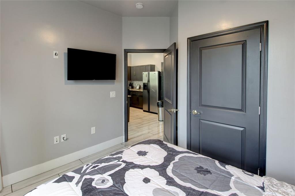 870 Mayson Turner Road Northwest, Unit 1102 Atlanta, GA 30314 - Photo 15 of 27 a bedroom with a bed and a television