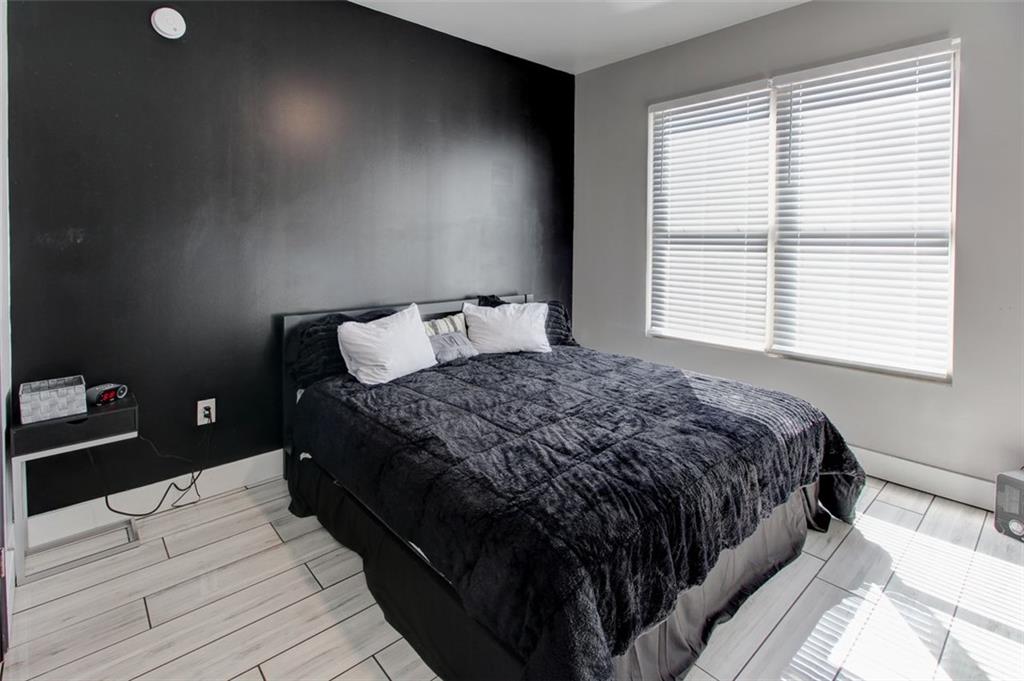 870 Mayson Turner Road Northwest, Unit 1102 Atlanta, GA 30314 - Photo 21 of 27 a bed sitting in a bedroom next to a window