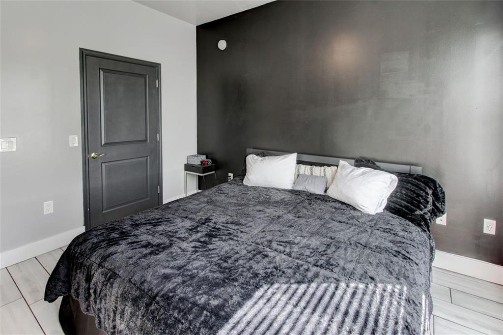 870 Mayson Turner Road Northwest, Unit 1102 Atlanta, GA 30314 - Photo 22 of 27 a bedroom with a bed and window