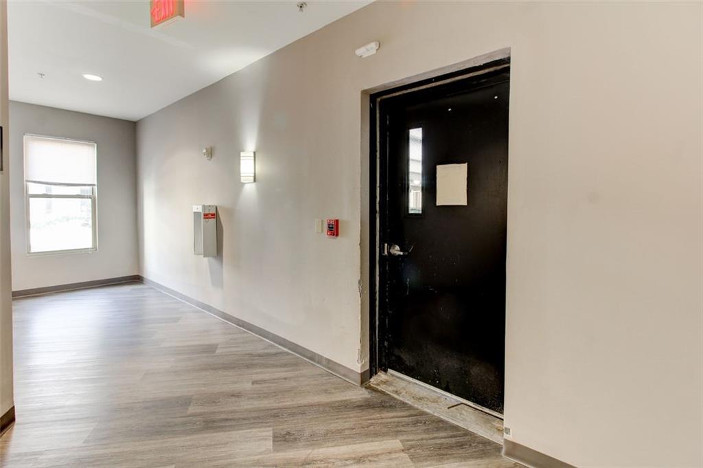 870 Mayson Turner Road Northwest, Unit 1102 Atlanta, GA 30314 - Photo 25 of 27 a view of hallway with wooden floor and staircase