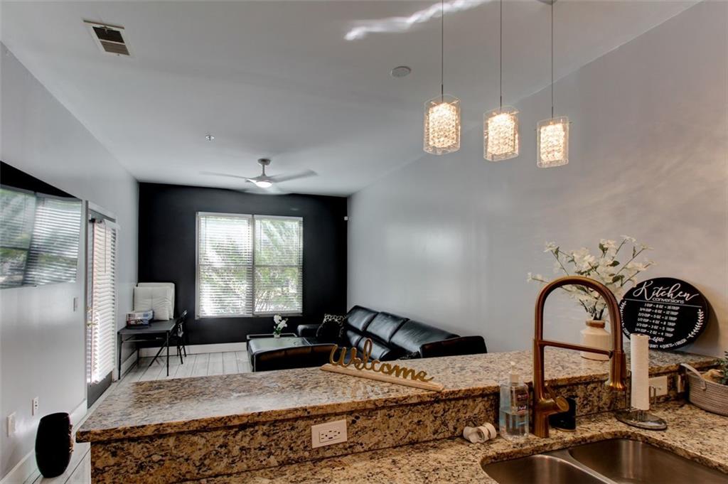 870 Mayson Turner Road Northwest, Unit 1102 Atlanta, GA 30314 - Photo 3 of 27 a kitchen with stainless steel appliances granite countertop a stove a sink and a refrigerator