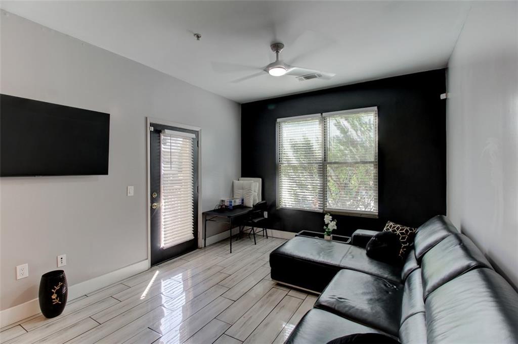 870 Mayson Turner Road Northwest, Unit 1102 Atlanta, GA 30314 - Photo 7 of 27 a living room with furniture and a flat screen tv
