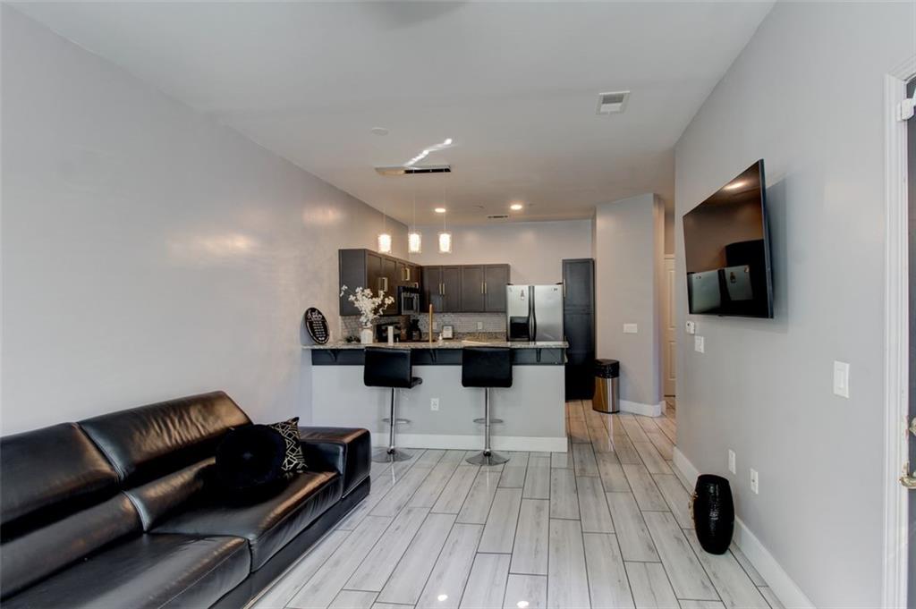 870 Mayson Turner Road Northwest, Unit 1102 Atlanta, GA 30314 - Photo 9 of 27 a living room with furniture and a flat screen tv