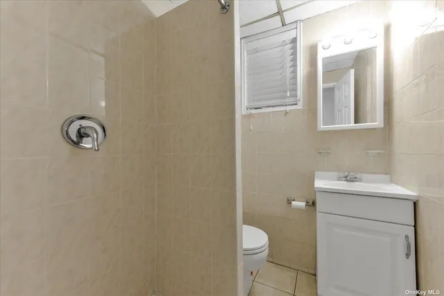 a bathroom with a toilet a sink a vanity and mirror