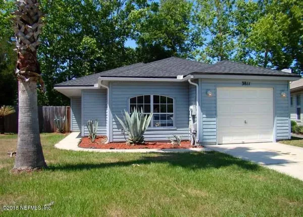 a front view of house with yard and outdoor seating