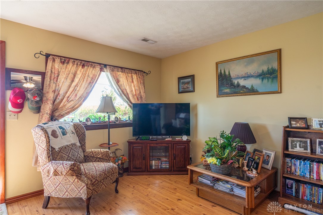 1599 Garringer Road Jamestown, OH 45335 - Photo 5 of 73 This inviting living room showcases beautiful hardwood flooring.